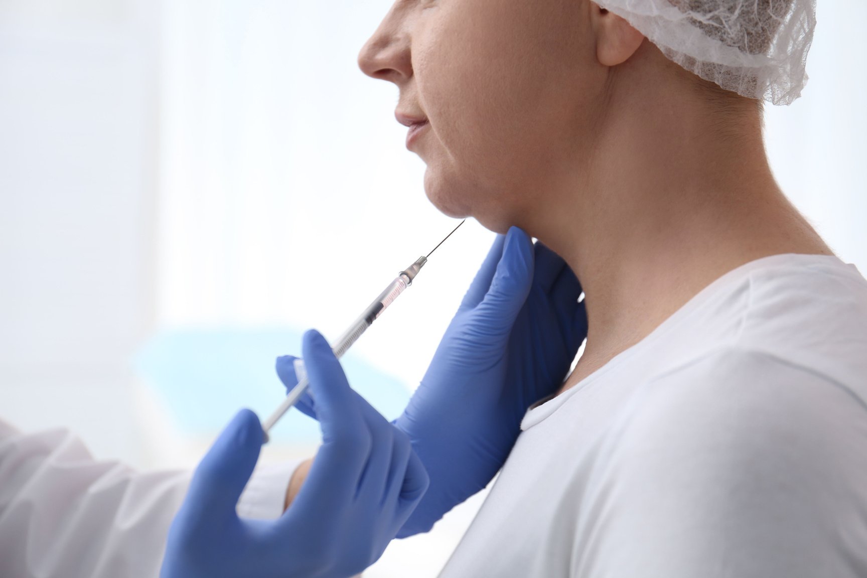 Mature Woman with Double Chin Receiving Injection in Clinic, Clo