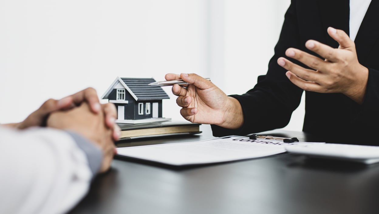 Real Estate Agent Showing Contract to Client